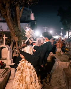 Couple in cemetery in Halloween costumes