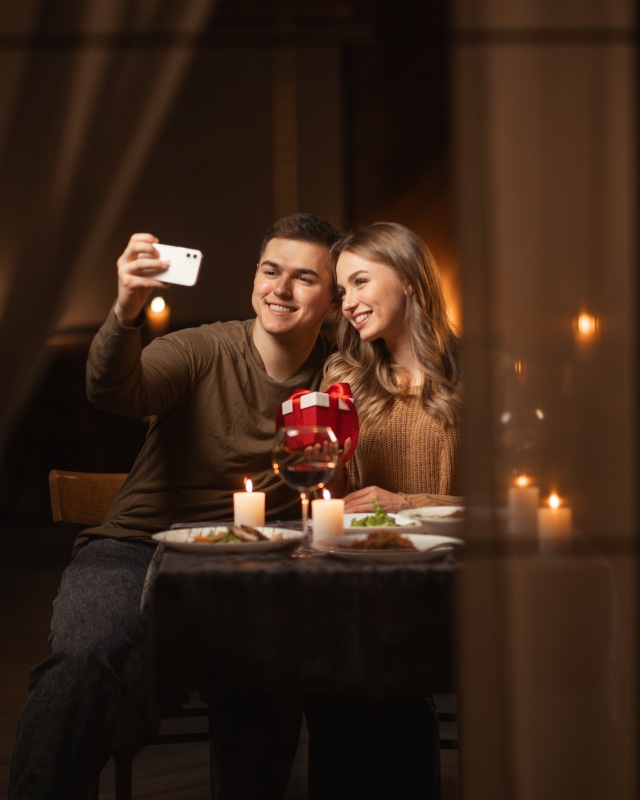 Couple taking selfie at dinner