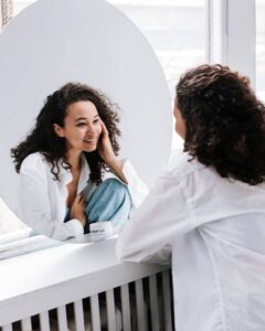 Woman looking into a mirror