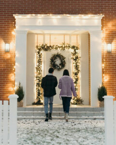 Couple standing outside a house