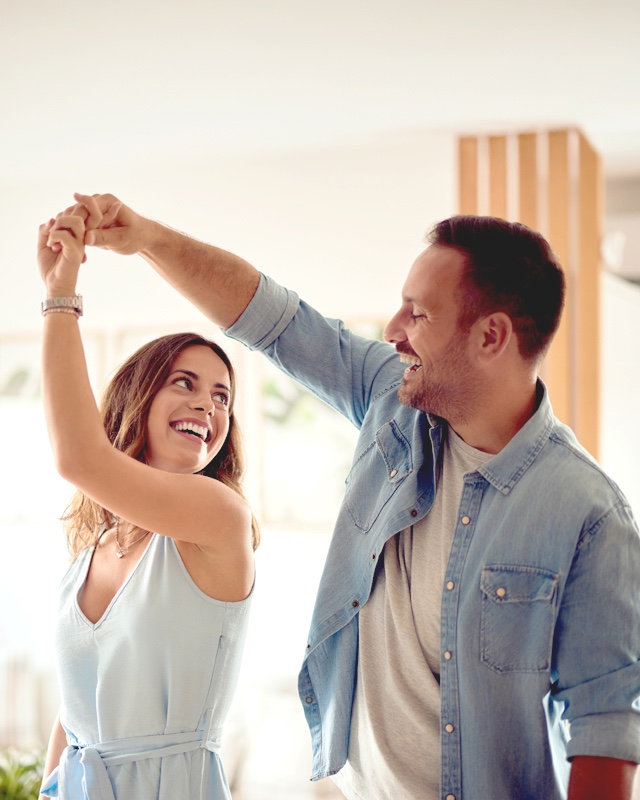 Couple dancing together at home