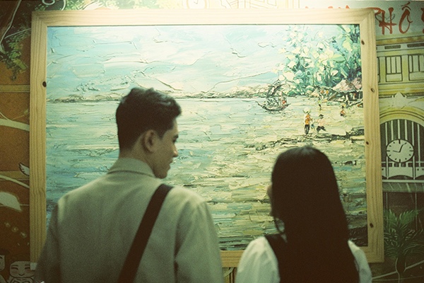 Couple Examining a Painting