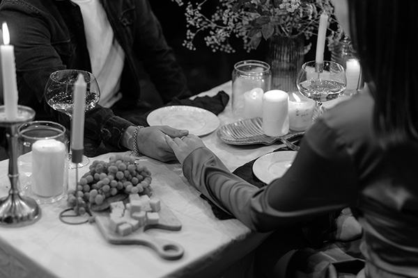 Couple holding hands at dinner