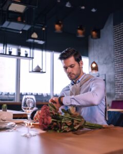 Man with flowers waiting on partner