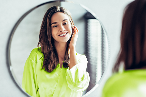 Woman smiling in a mirror